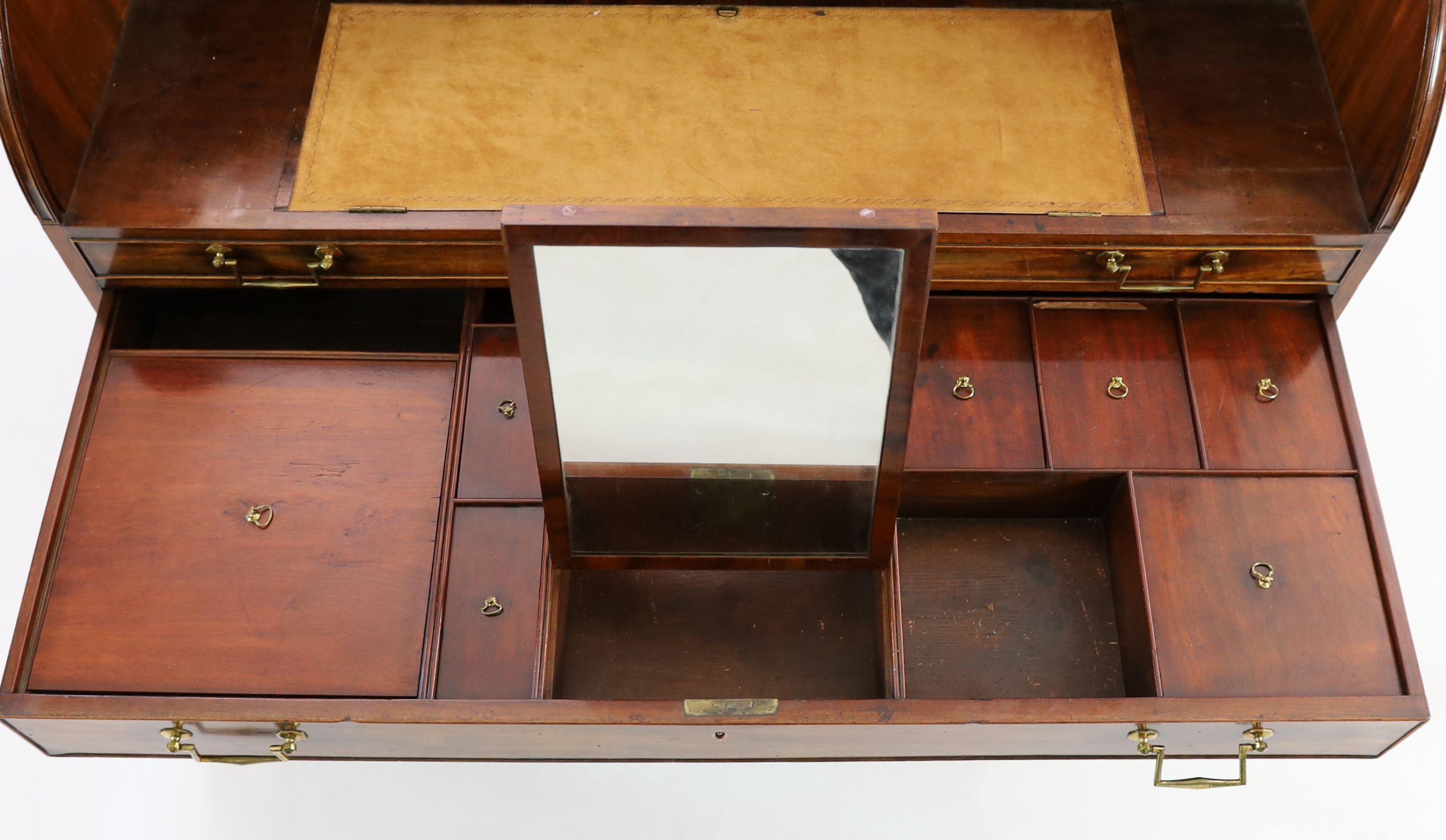 A George III mahogany cylinder top combined writing and dressing kneehole desk, W.122cm D.61cm H.110cm